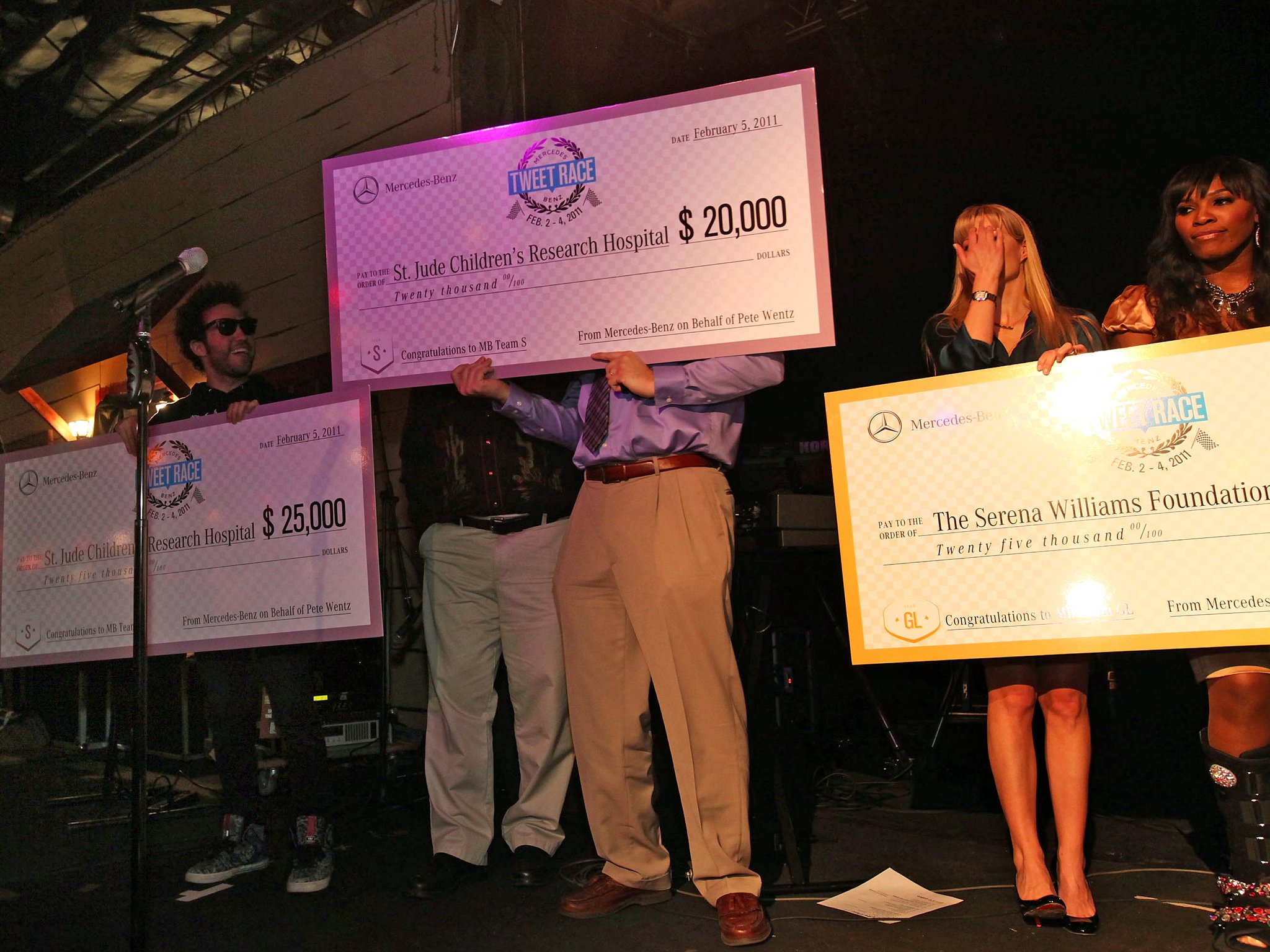 Todd Sanders holding a $25,000 check for St. Jude Children's Research Hospital at the Tweet Race finish line